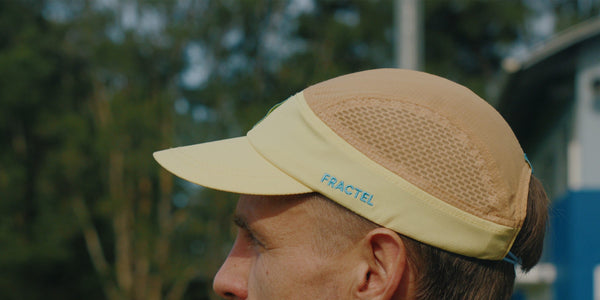 Pale yellow Fractel city series running cap with a mesh side panel and blue logo