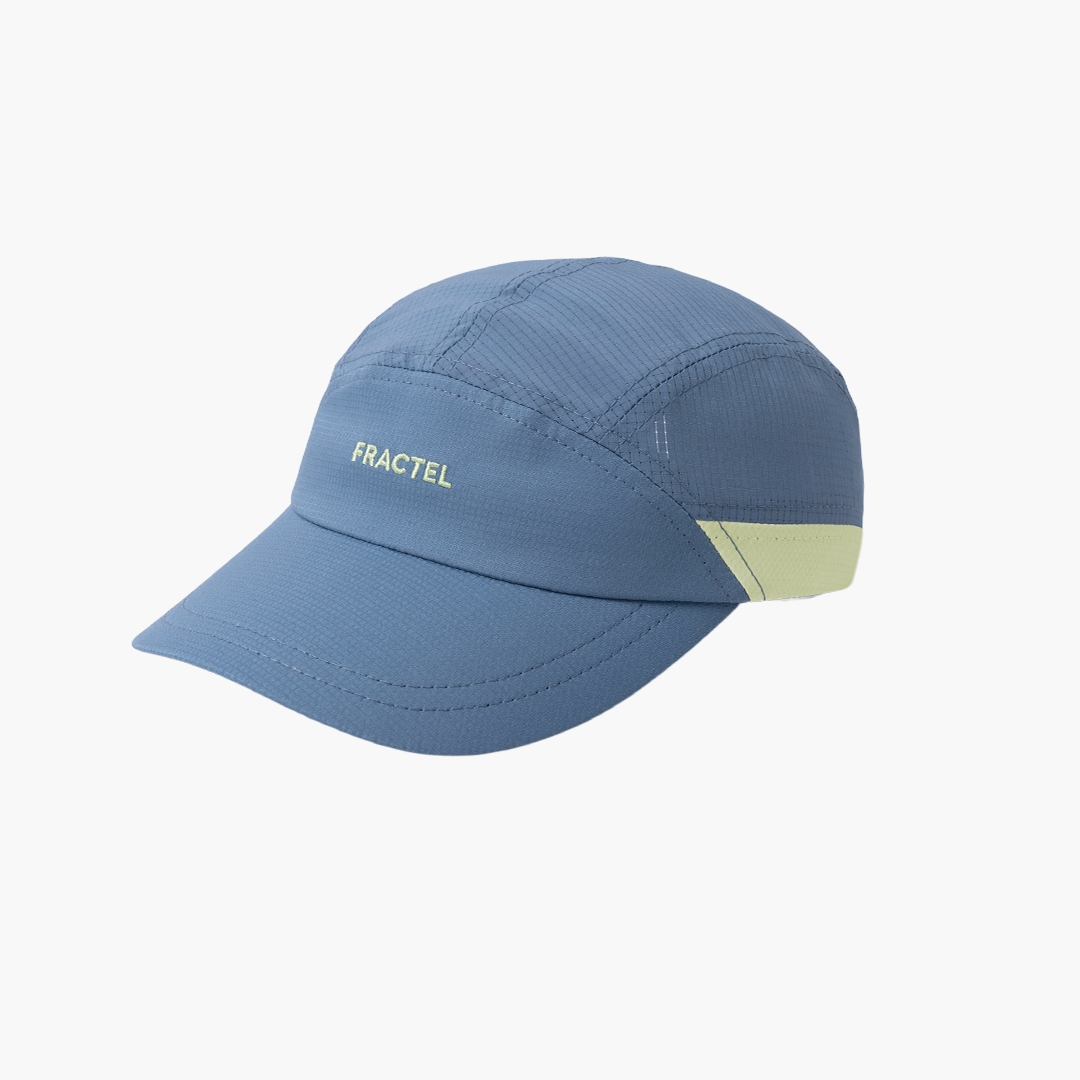 A slate blue Fractel running cap with a light green embroidered logo on the front and a matching light green accent panel on the side, shown against a plain white background.