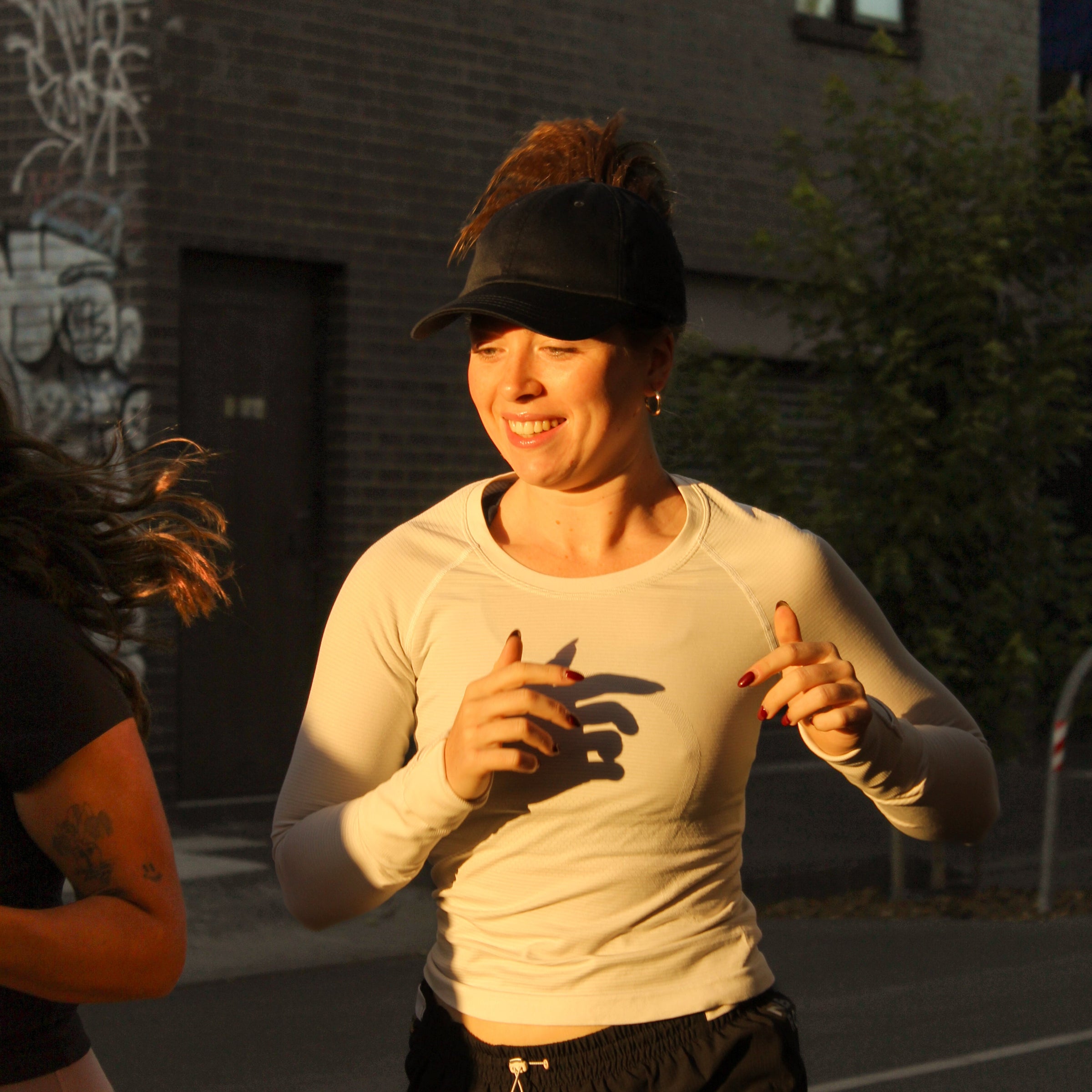 Runner wearing C-ASHEN High Ponytail Running Cap outdoors