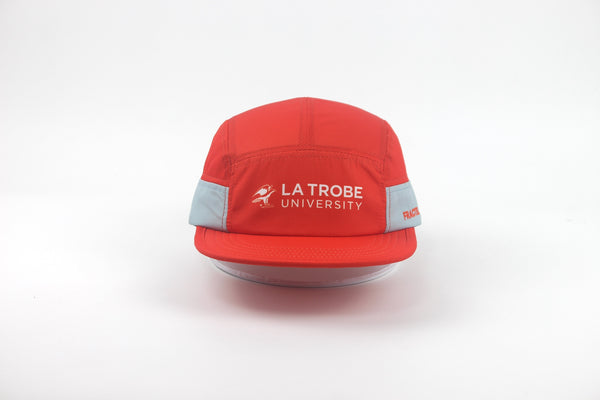 A red 5-panel cap with a flat visor, featuring light gray side panels and white 'LA TROBE UNIVERSITY' text on the front, shown against a plain white background.