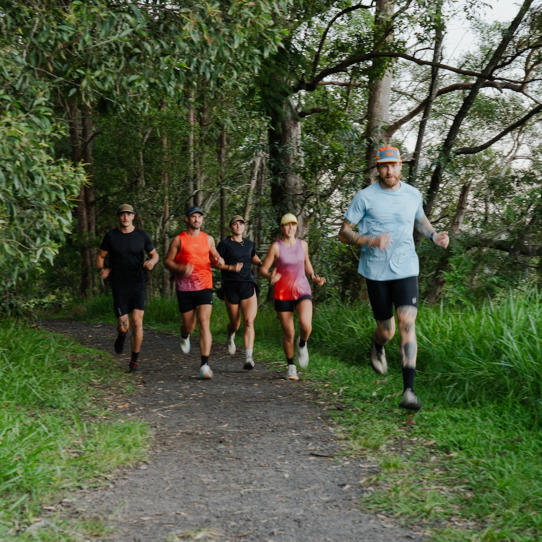 Group of runners on a trail in a forest