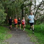Group of runners on a trail in a forest