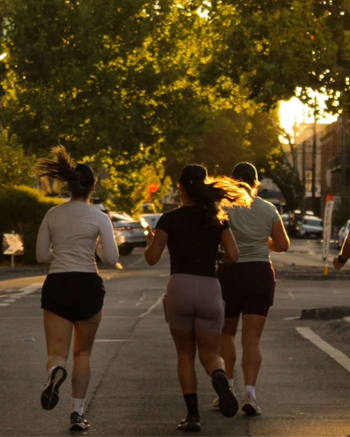 Casual running caps with a ponytail opening worn by runners on a city street