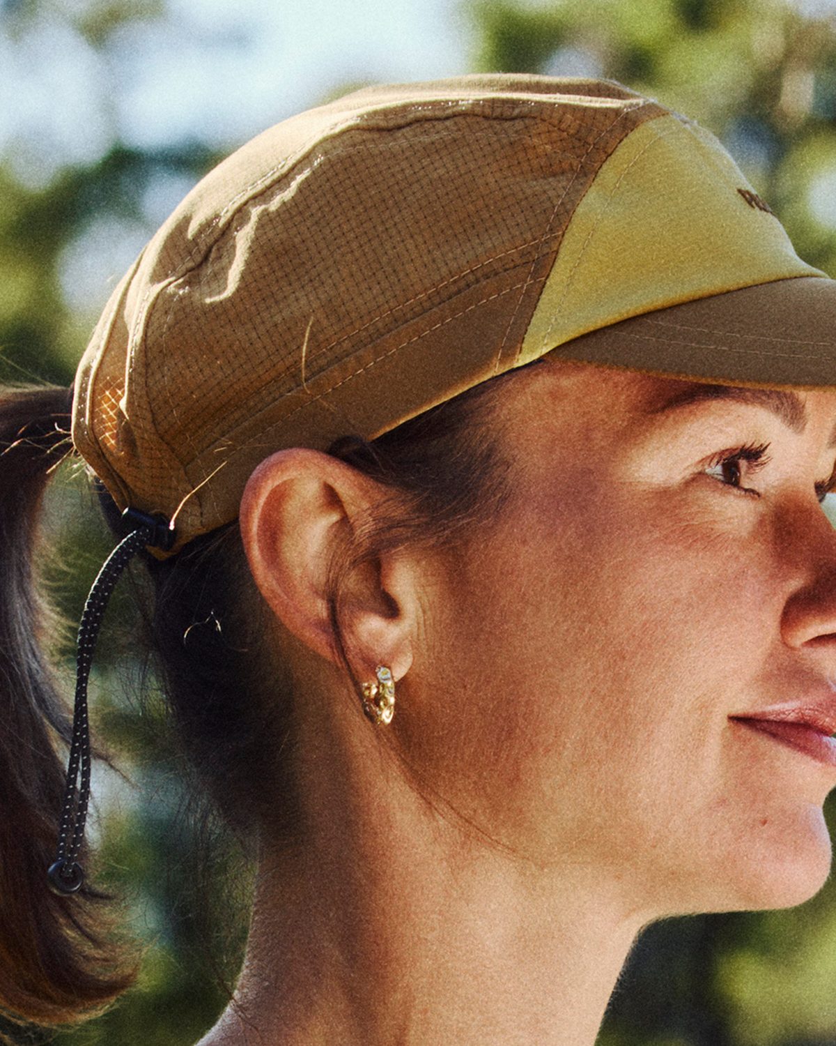 Lightweight e series running cap in tan worn with a high ponytail