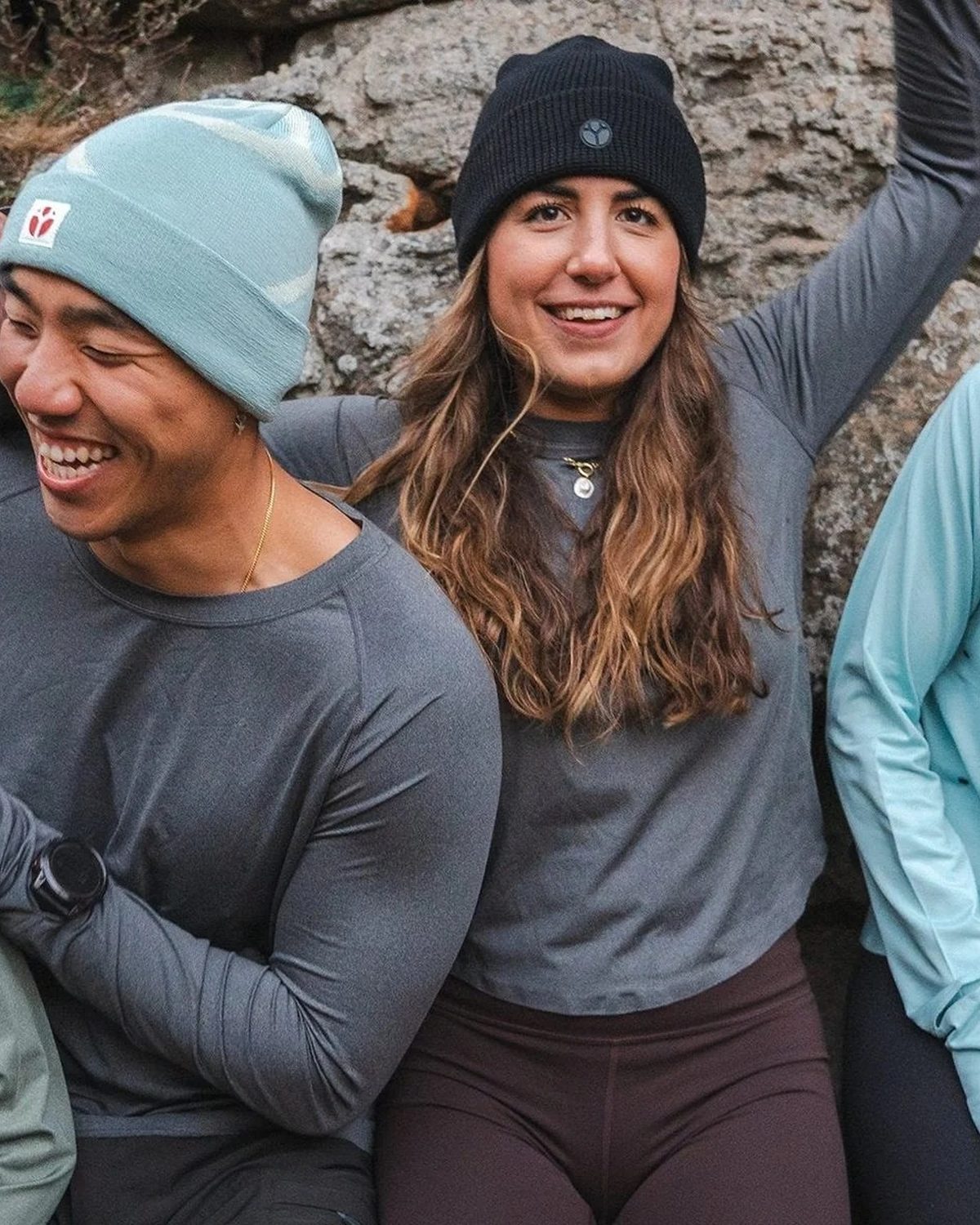 S-Series lightweight running beanie in light blue worn by a laughing runner